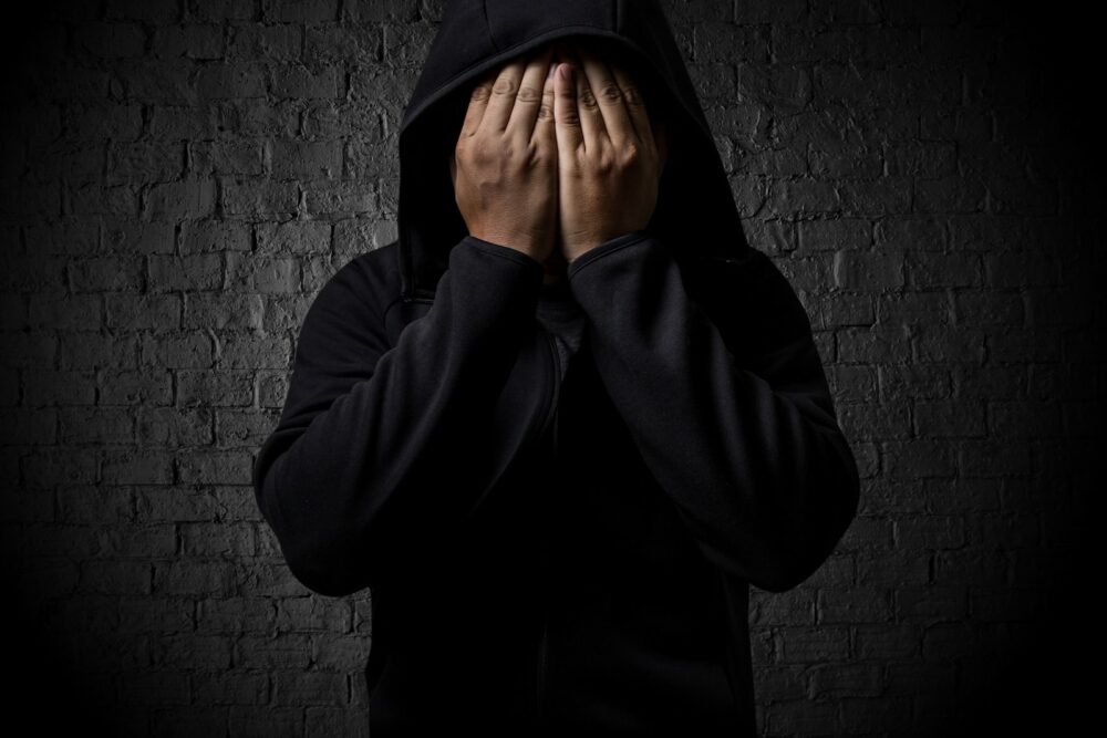 Addicted man in a black hoodie