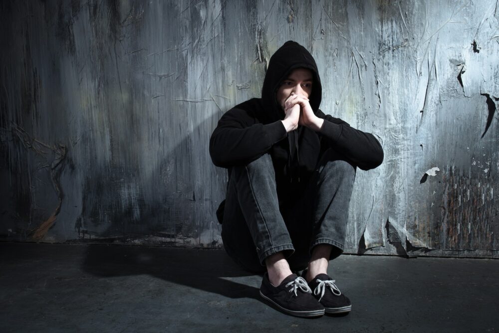 Stressed man in a black hoodie