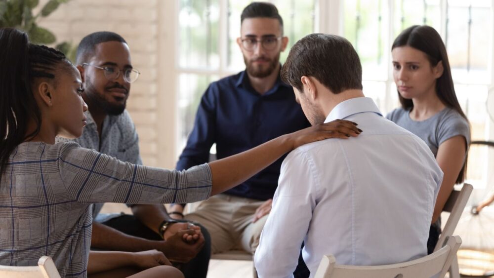Man in pain in group therapy