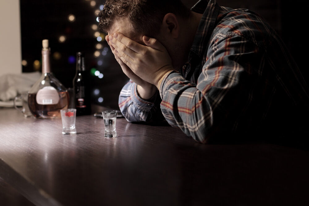 A sad man sitting at the bar