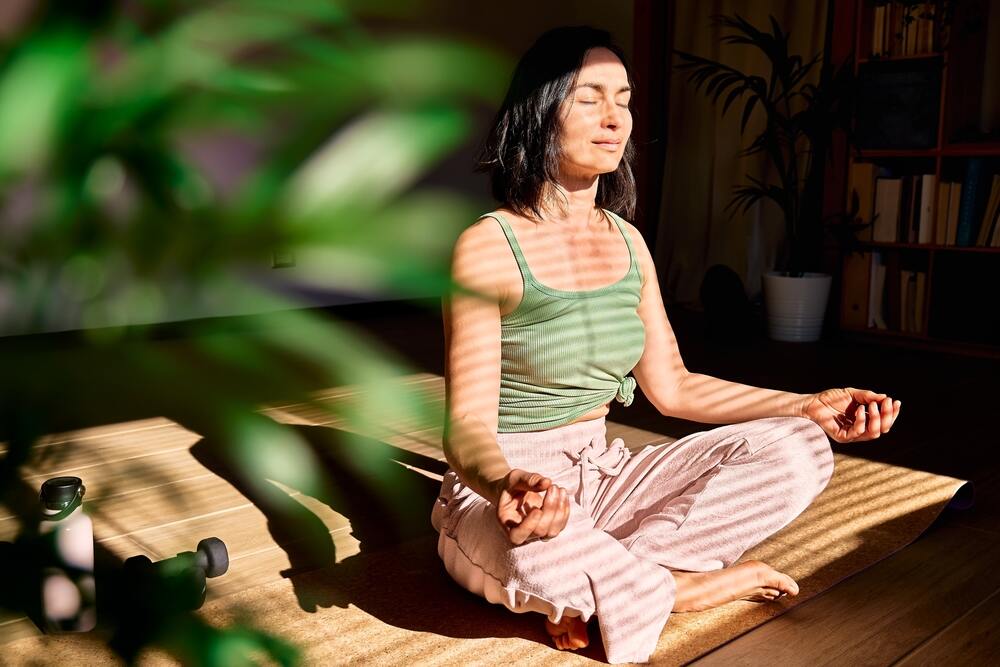 A woman meditating on the floor